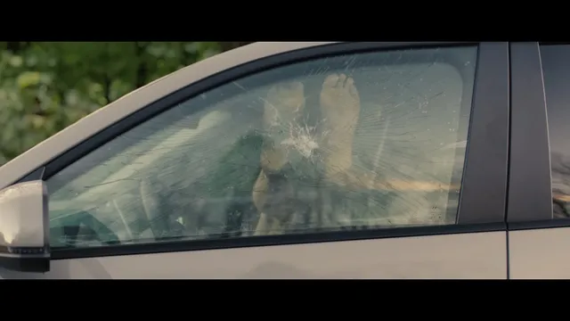 Sophie Thatcher sitting inside a car in a film scene.