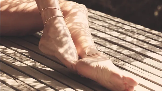 Megan Fox: close view of bare feet on wooden decking.