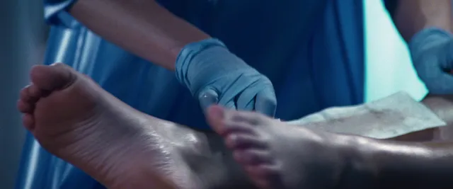 Jennifer Lawrence showing bare soles in a close-up screen scene.