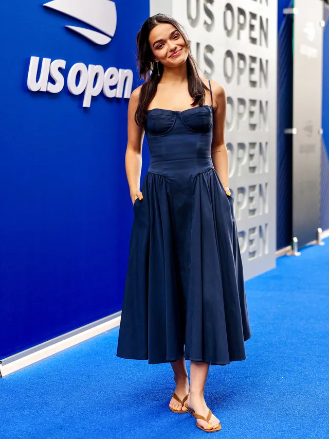 Rachel Zegler wearing a blue dress and gold flat sandals at the US Open.