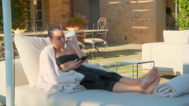 Kim Kardashian: reclining barefoot on an indoor lounger.