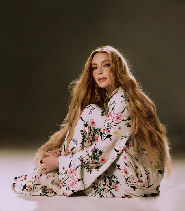 Lindsay Lohan sitting in a floral outfit for a portrait.
