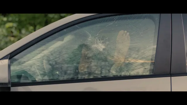 Sophie Thatcher looking out through a car window in a film scene.