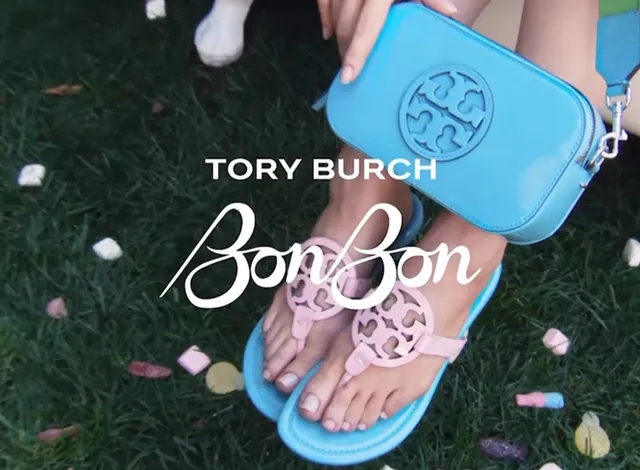 Madelaine Petsch wearing blue flower decorated flat sandals in a close detail.