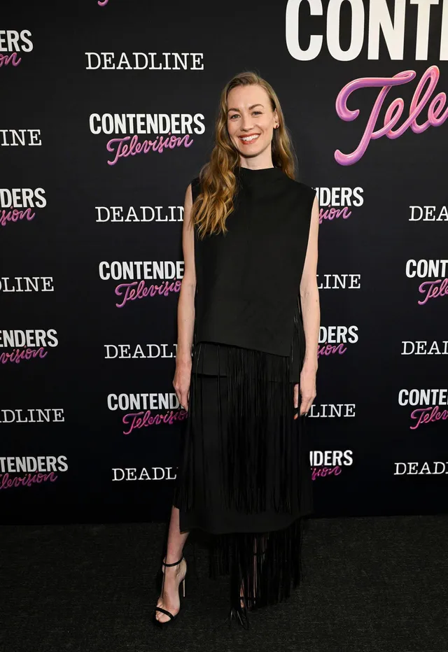 Yvonne Strahovski posing at a television event in a long black dress.