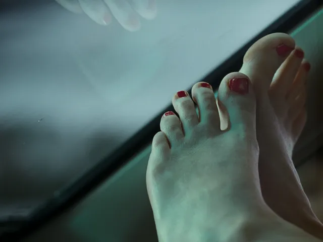 Jennifer Lawrence showing painted bare toes and a sole in a close-up.