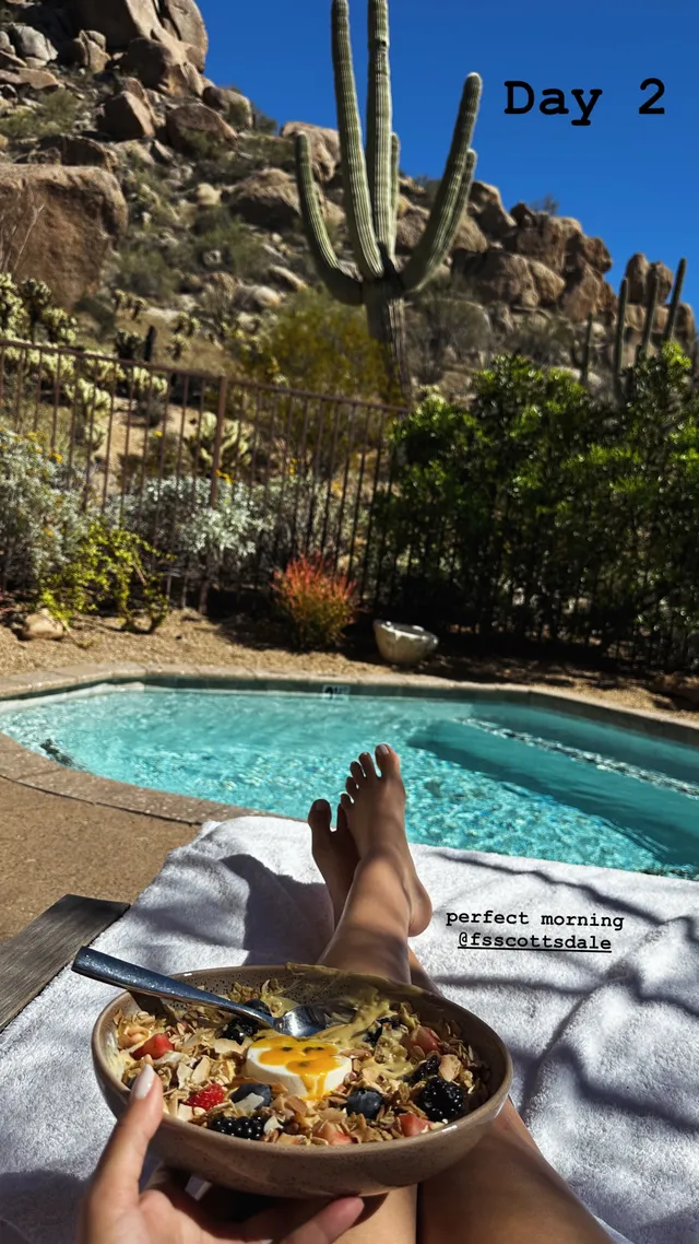 Victoria Justice resting beside a pool with food and bare feet visible.