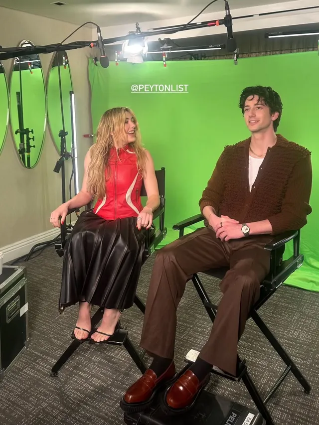 Peyton List sitting in black heels during an interview.