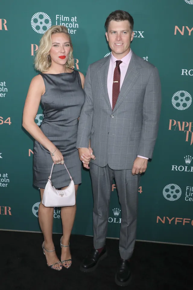 Scarlett Johansson posing beside a companion at an event.
