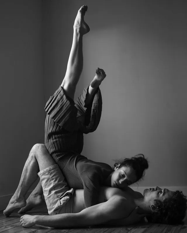 María Pedraza posing barefoot with a partner for a monochrome dance portrait.