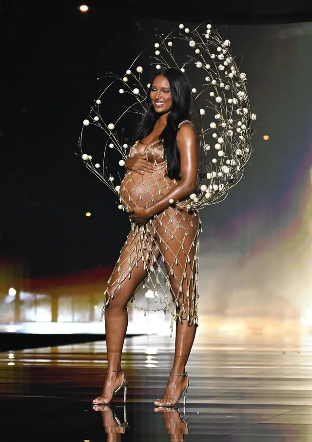 Jasmine Tookes wearing heels and an embellished outfit with decorative wings.