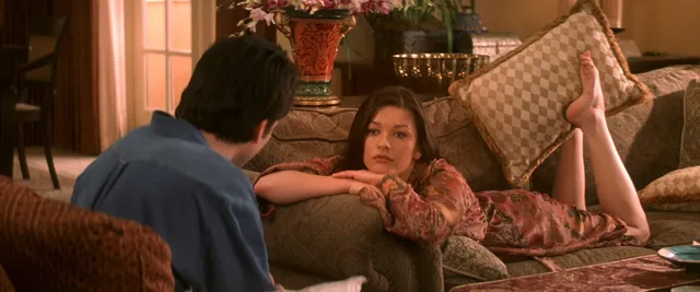 Catherine Zeta-Jones a reclining screen scene on a sofa.