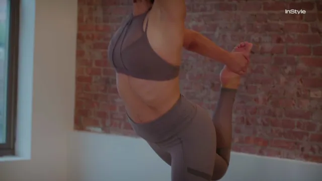 Nathalie Emmanuel balancing during a studio yoga session.