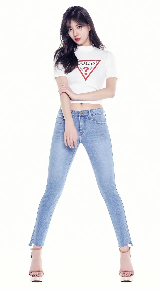 Bae Suzy posing in jeans and pale heels.