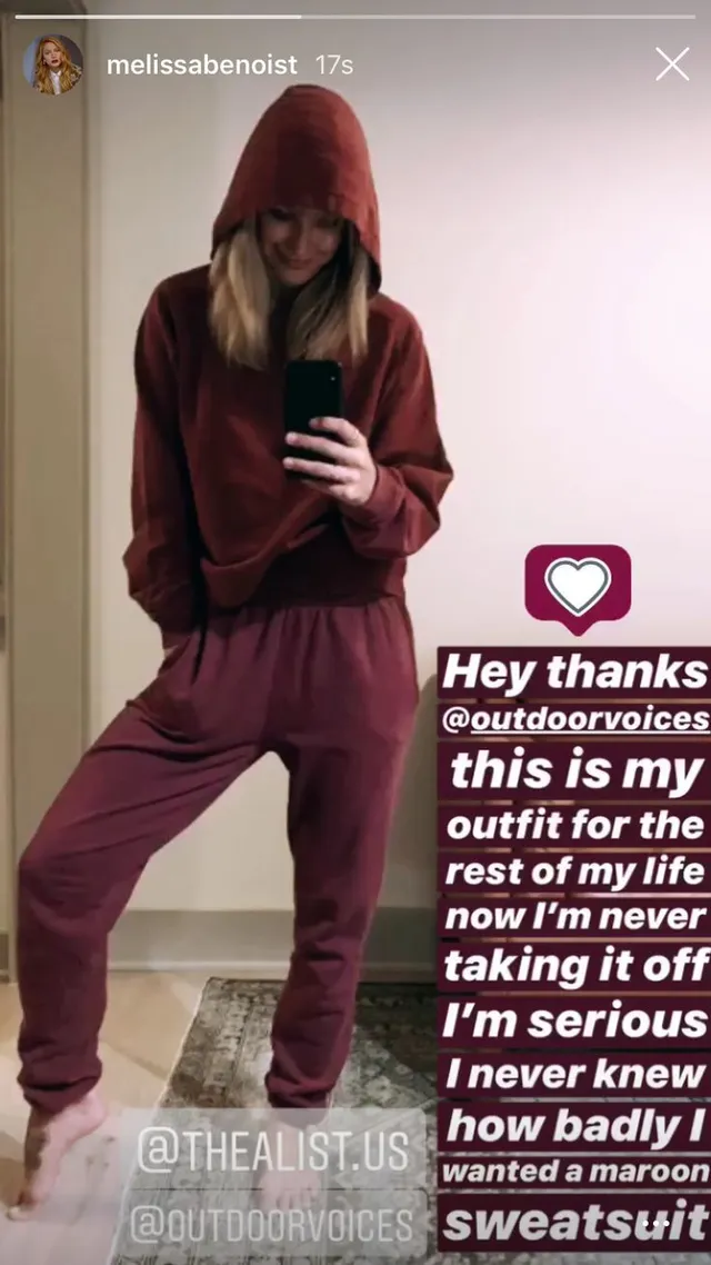 Melissa Benoist posing barefoot in a casual hooded outfit for a mirror photo.
