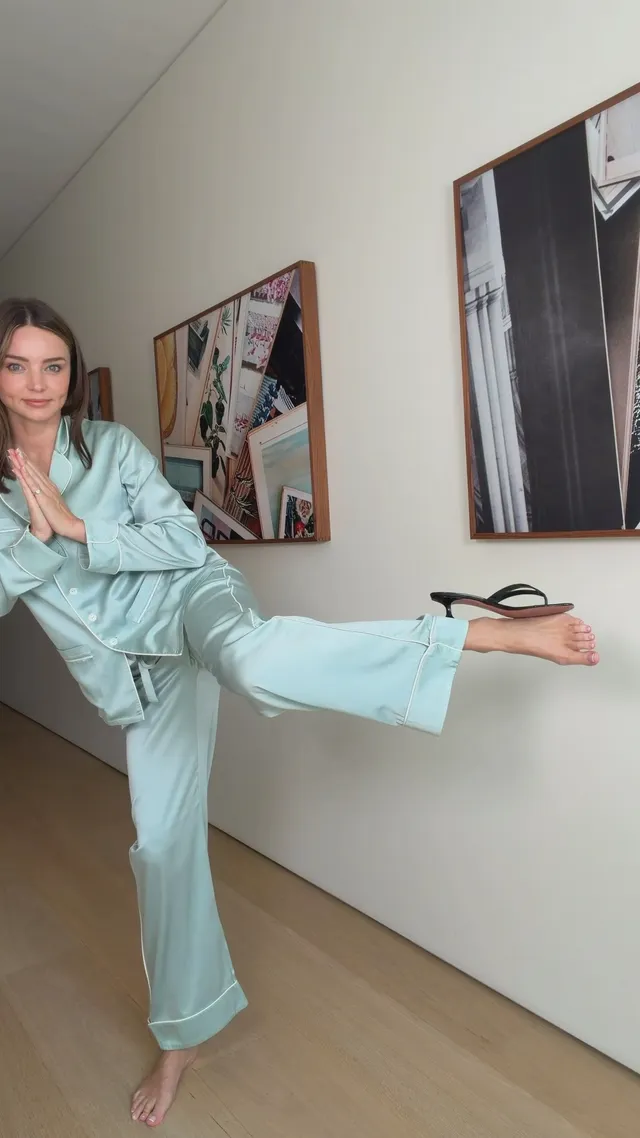 Miranda Kerr a light blue outfit with one leg raised.