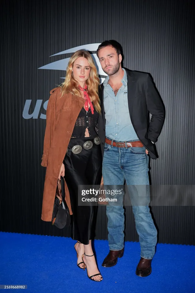 Grace Van Patten posing beside a man at the US Open in black heels.