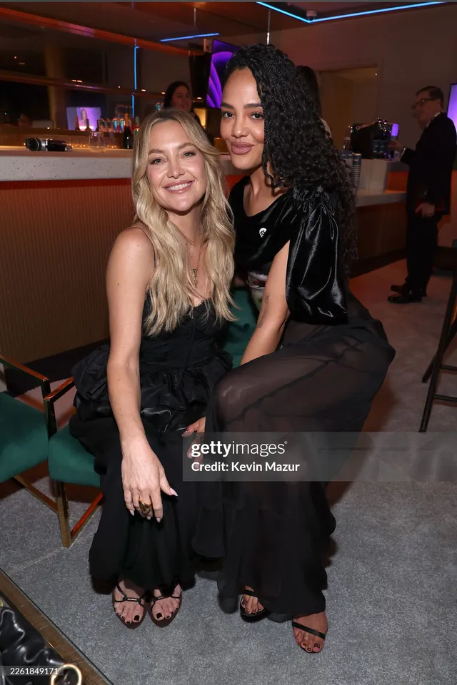 Tessa Thompson sitting beside a guest in a black outfit.