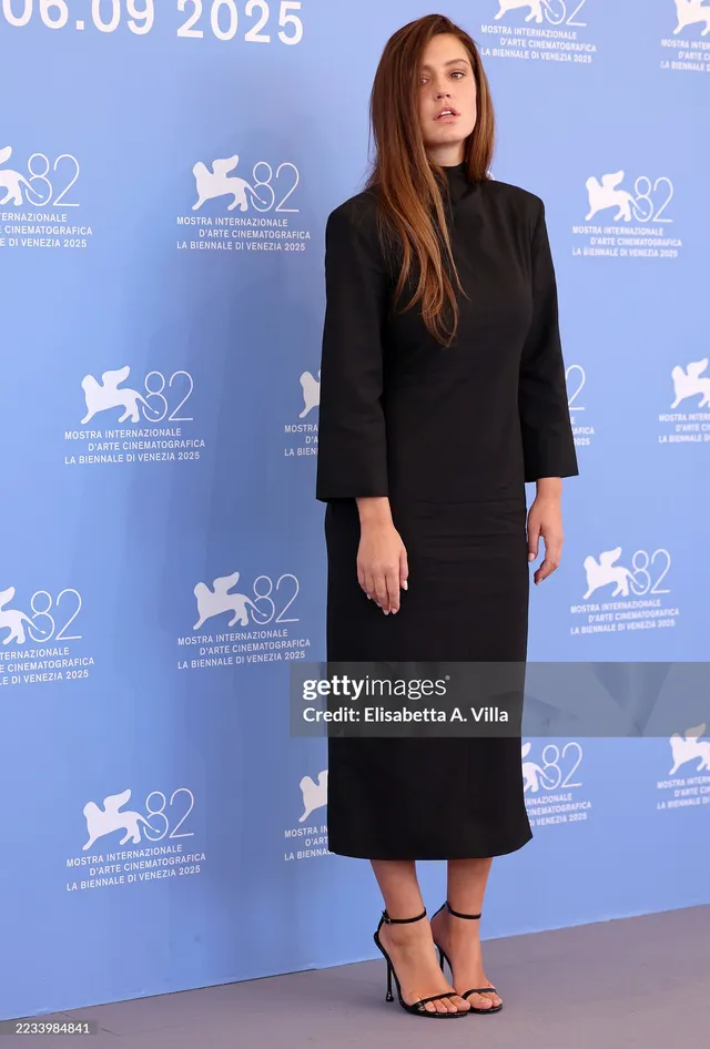 Adèle Exarchopoulos posing at a film festival in a long black dress.