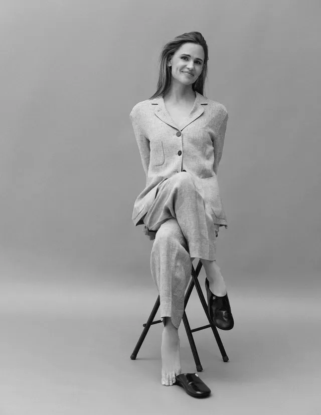 Jennifer Garner sitting on a stool for a black-and-white portrait.