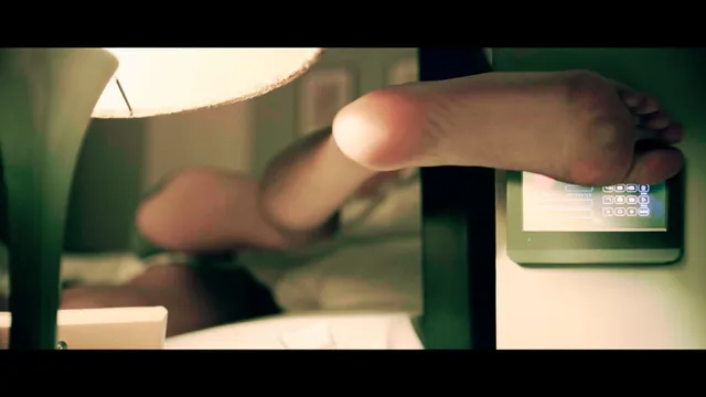 Gal Gadot resting a bare sole on a chair in a screen scene.