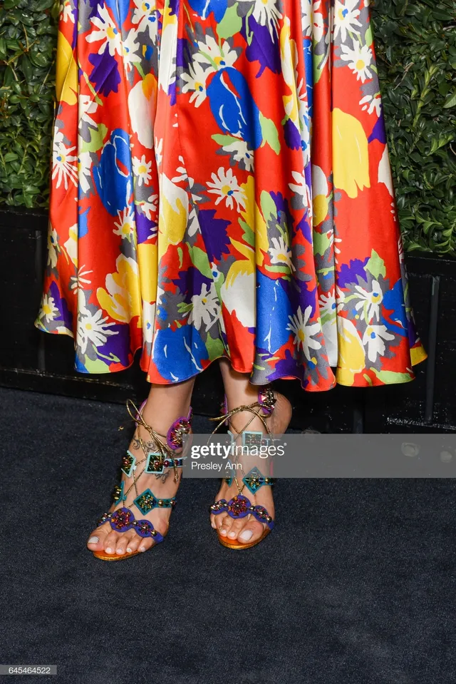 Deepika Padukone wearing patterned sandals beneath a colourful floral skirt.