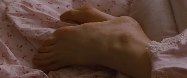 Natalie Portman resting a bare foot in a close-up screen scene.