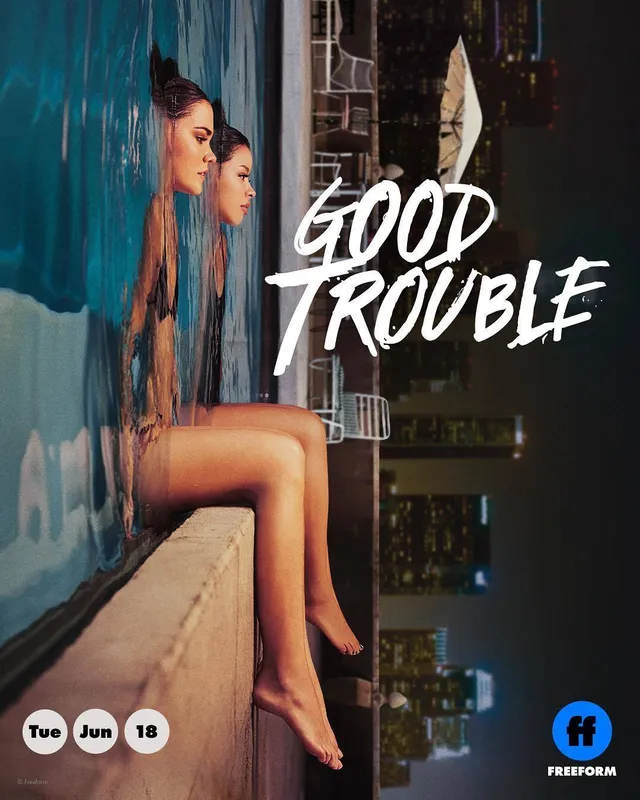 Maia Mitchell sitting barefoot on a ledge in a promotional photograph.