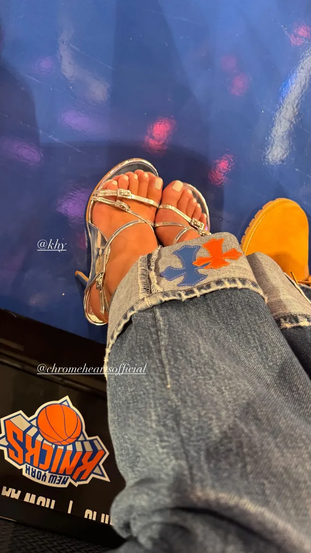 Kylie Jenner wearing embellished heels beneath jeans.