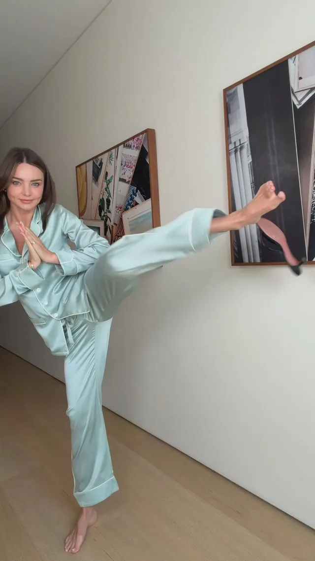 Miranda Kerr a light blue outfit in a standing stretch.
