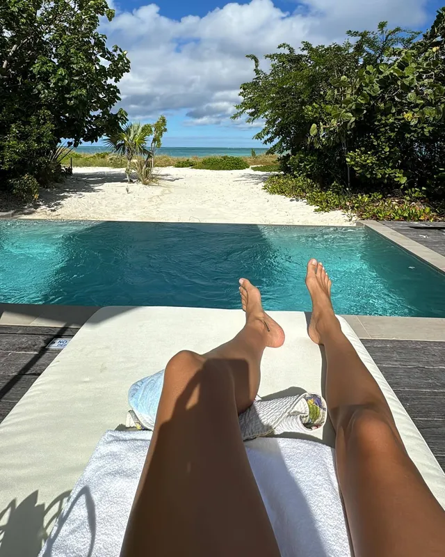 Irina Shayk a view of bare feet overlooking a swimming pool.