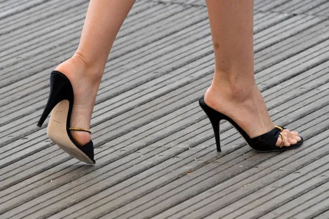 Ana de Armas wearing black open-toe shoes in a close-up.