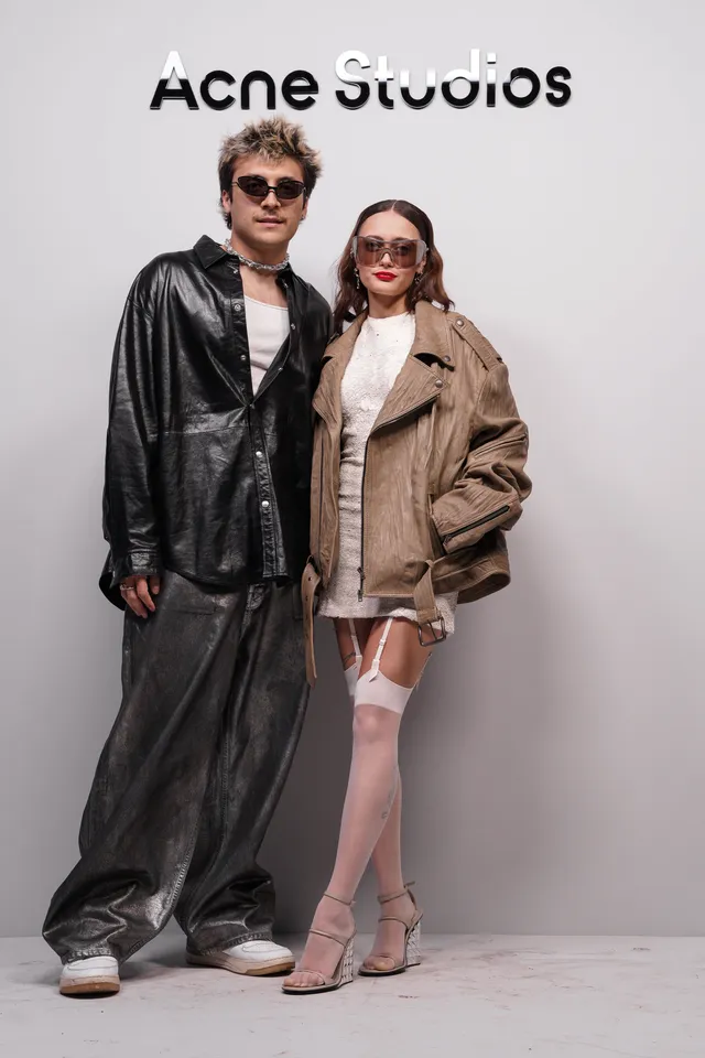 Ella Purnell posing with a guest at a fashion event.