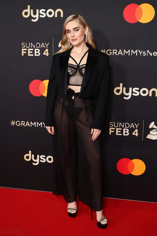 Meg Donnelly wearing a dark trouser outfit and black heels at a music event.