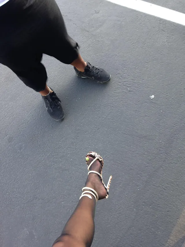 Tyla wearing pale strappy heels in an overhead street photograph.