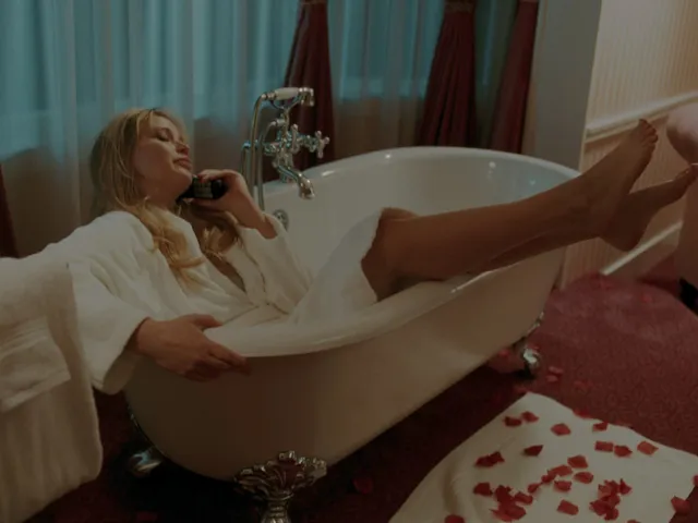 Jennifer Lawrence resting bare feet over the edge of a bathtub.