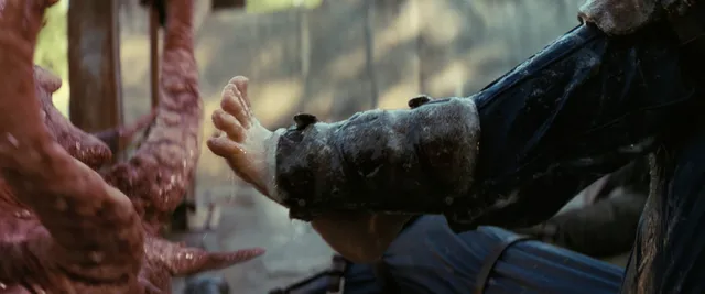 Ella Purnell lying beside a character in a dramatic screen scene.