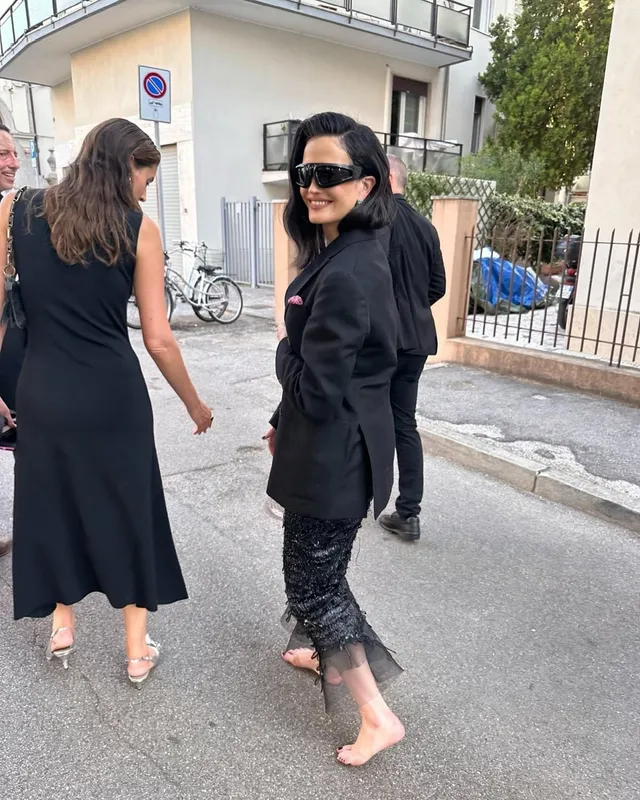 Eva Green walking outdoors in a black outfit.