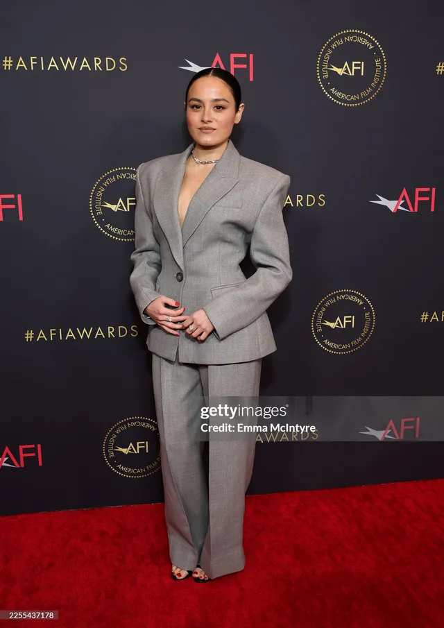 Chase Sui Wonders wearing a grey suit and heels at an awards event.