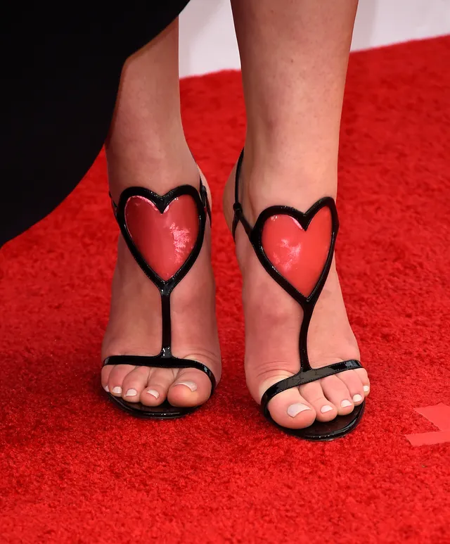 Sophie Turner a close-up of black heels with heart-shaped straps.