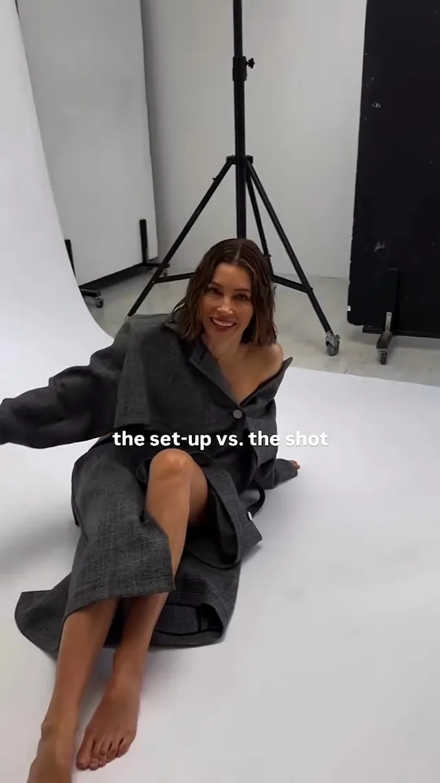 Jessica Biel a seated studio photograph in a grey outfit.