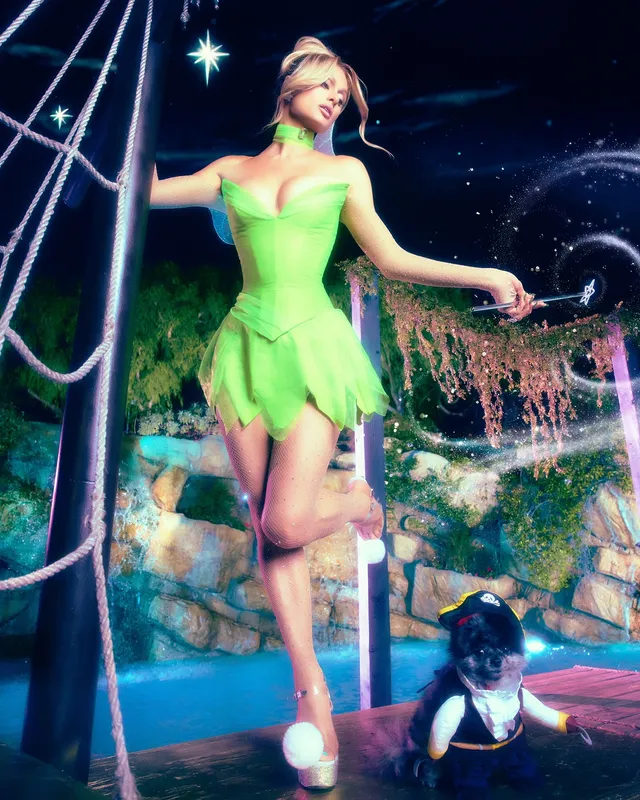 Paris Hilton wearing a green costume on a stage.