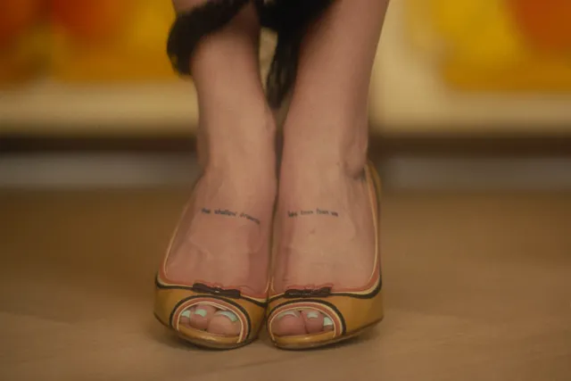 Madelyn Cline wearing gold open-toe heels in a close-up.