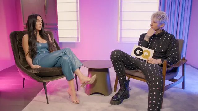 Megan Fox sitting opposite a television interviewer.