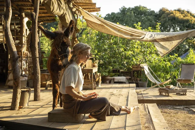 Vanessa Kirby a seated screen scene beside an outdoor hammock.
