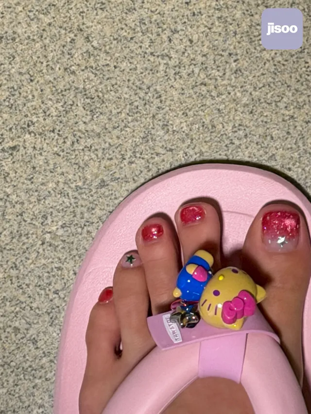 Jisoo showing decorated toenails while wearing pink flat sandals.