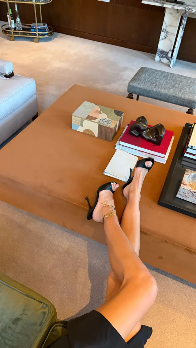 Irina Shayk resting with bare feet in a lounge.