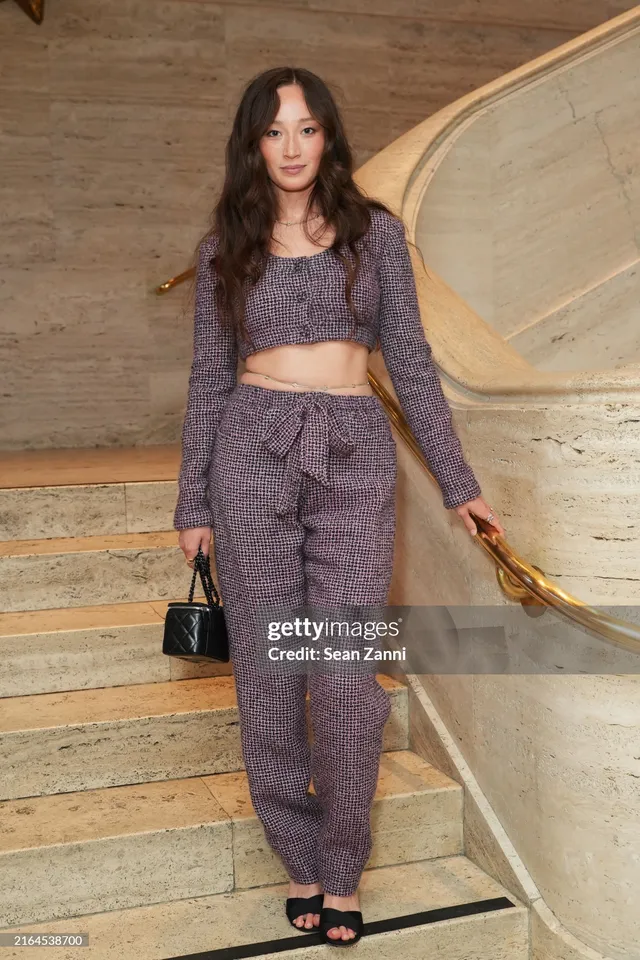 Havana Rose Liu wearing a patterned trouser outfit and black heels.