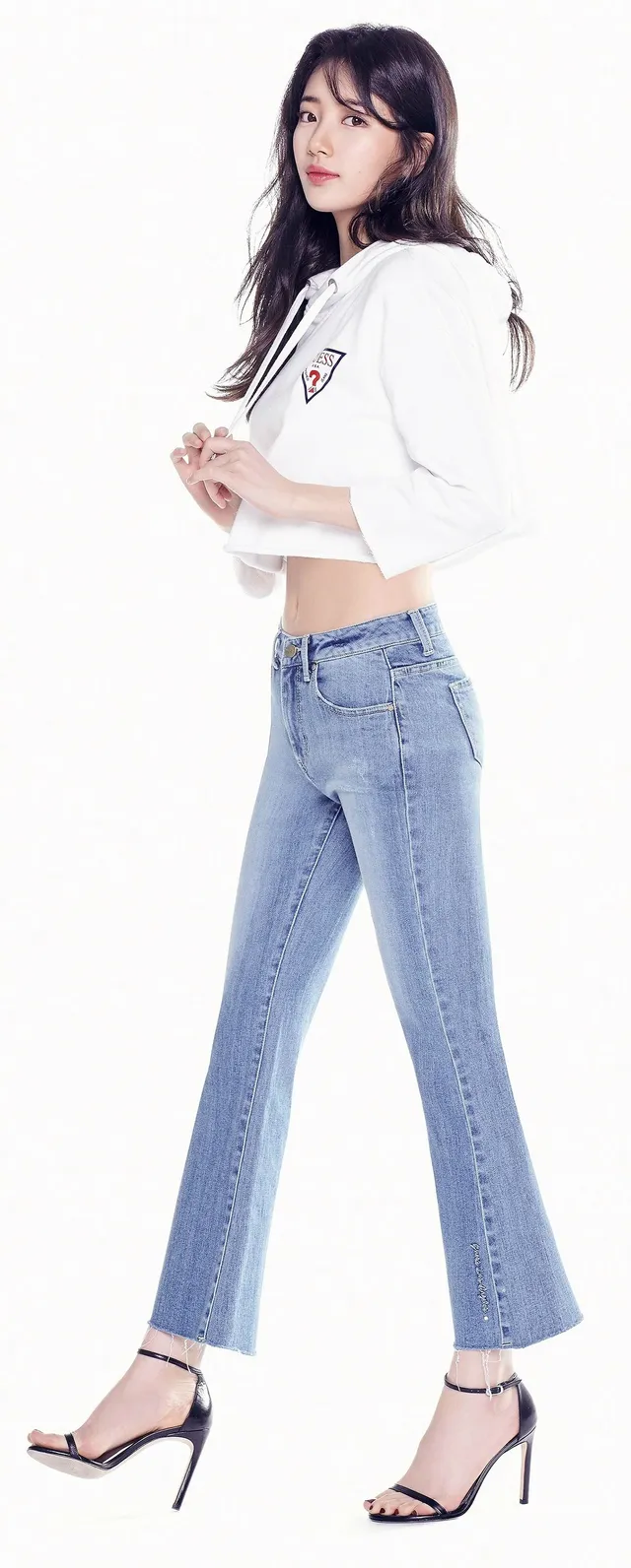 Bae Suzy posing in jeans and black heels.
