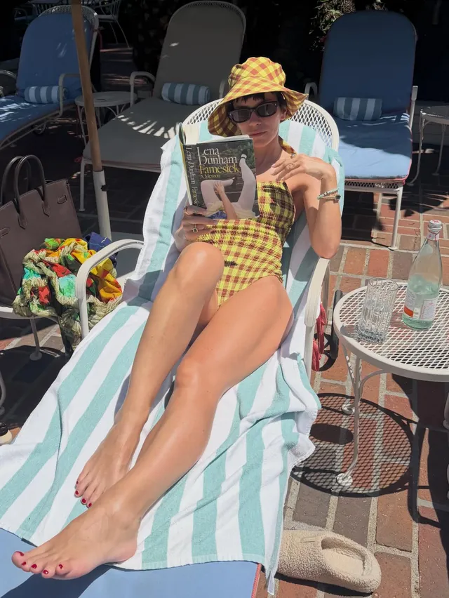 Lily Allen: reclining barefoot on an outdoor sun lounger.